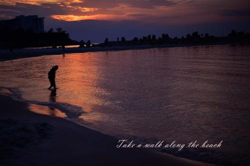 a person standing on the beach watching the sunset at STEP by STEP - Vacation STAY 25753v in Kanayama
