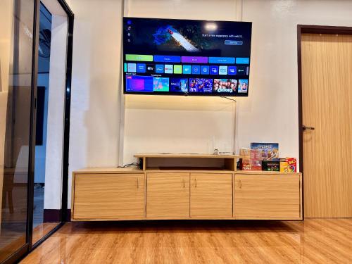 a flat screen tv on a wall in a room at Entire Home in Pampanga in San Fernando