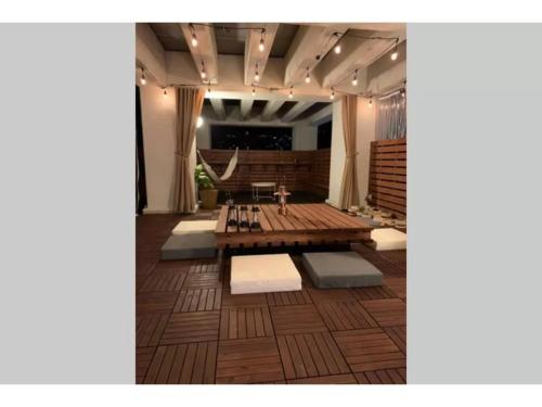 a living room with a wooden table and a couch at gate nagasaki stay&green - Vacation STAY 27220v in Nagasaki