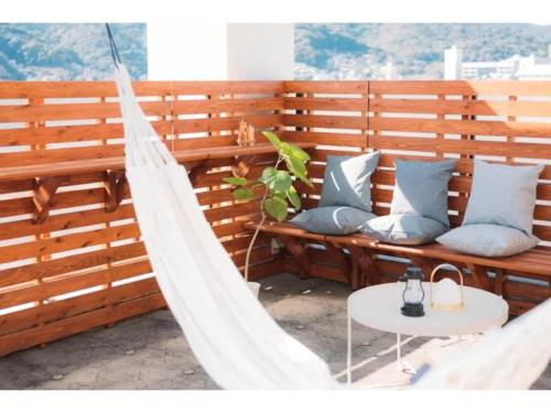 a hammock on a patio with a table and a table at gate nagasaki stay&green - Vacation STAY 27220v in Nagasaki