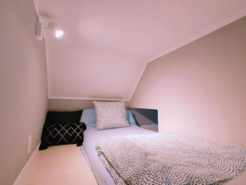 a small bedroom with a bed in a attic at MeMe Inn - Vacation STAY 10729 in Saitama