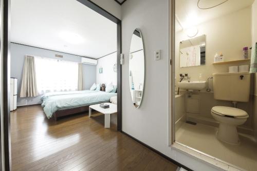 a bathroom with a bed and a toilet and a sink at Flat piece chair house - Vacation STAY 21975v in Fuzuchi