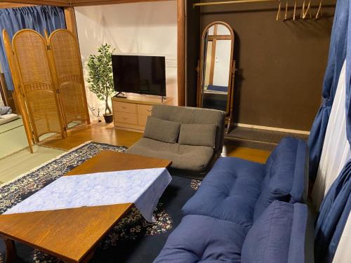 a living room with a couch and a tv at Ise Toyohama Villa - Vacation STAY 11133 in Ise