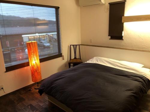 a bedroom with a bed and a large window at Nikko, Matsubara no Yado - Vacation STAY 31914v in Nikko