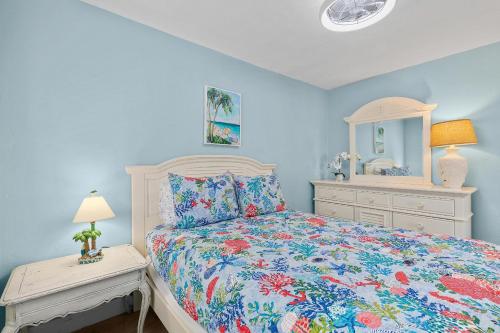 a bedroom with a bed and a dresser and a mirror at Flagler Suites 4 in New Smyrna Beach