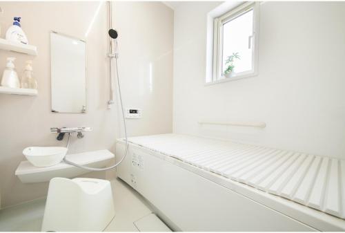 a white bathroom with a toilet and a window at Nasushiobara Renga no ie SORA - Vacation STAY 10890 in Nasushiobara