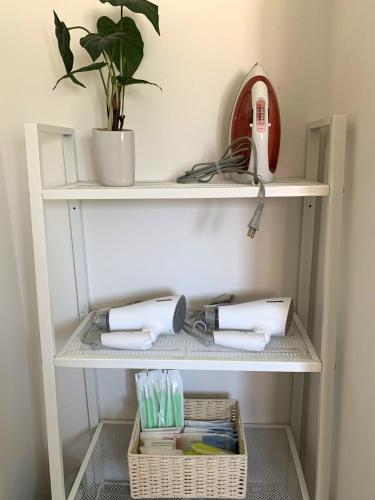 a shelf with a hair dryer and a plant at Nasushiobara Renga no ie SORA - Vacation STAY 10890 in Nasushiobara