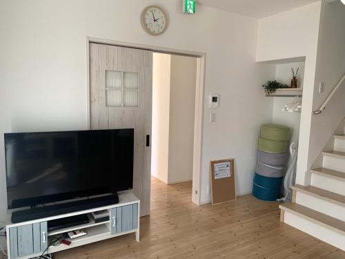 a living room with a flat screen tv on a entertainment center at Nasushiobara Renga no ie SORA - Vacation STAY 10890 in Nasushiobara