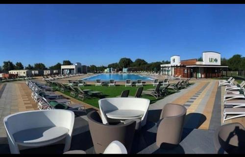 a row of chairs and a swimming pool at Larch View in Tattershall