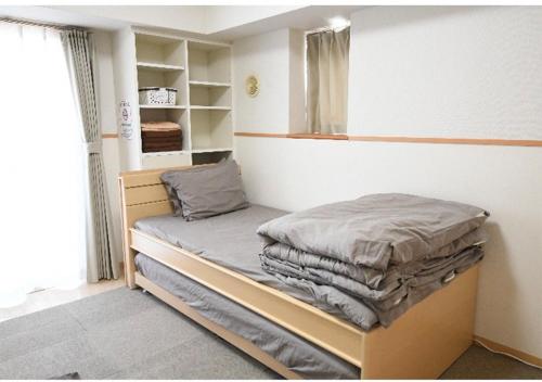 a small bedroom with a bed and a window at Marvelous Kokubunji - Vacation STAY 29877v in Kokubunji