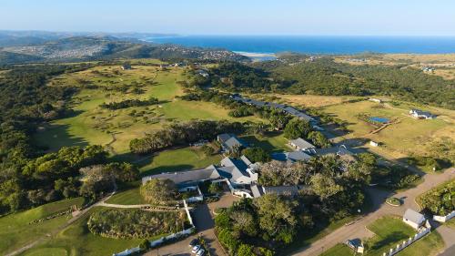 an aerial view of a house with the ocean in the background at Hotel Olivewood in East London