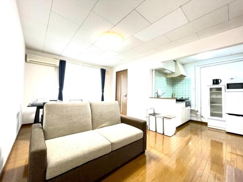 a living room with a couch and a kitchen at Avidasion - Vacation STAY 11967 in Biei