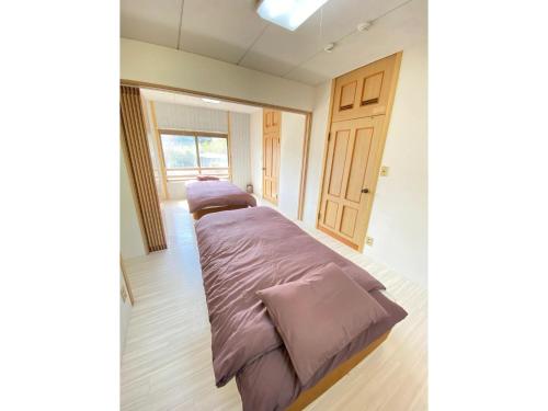 a bedroom with two beds with purple blankets in it at Trust Maison Ito Hagi - Vacation STAY 32263v in Ito