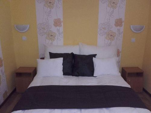 a bedroom with a large bed with white sheets and pillows at Réka Vendéghàz in Tokaj