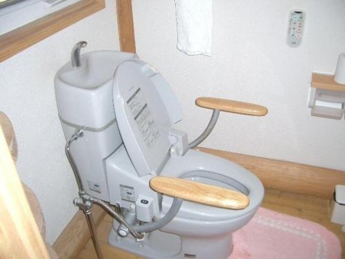 a bathroom with a toilet with the lid up at Log house for 12 people - Vacation STAY 35071v in Minamioguni