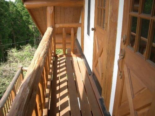 a wooden porch of a cabin with a door at Log house for 12 people - Vacation STAY 33957v in Minamioguni