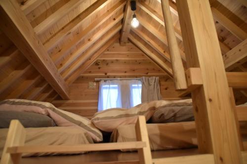 a room with two bunk beds in a wooden attic at Guest House Fukuchan - Vacation STAY 83847v in Kaiyo