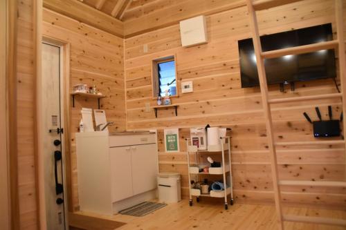 a log cabin with a refrigerator and a television at Guest House Fukuchan - Vacation STAY 83847v in Kaiyo