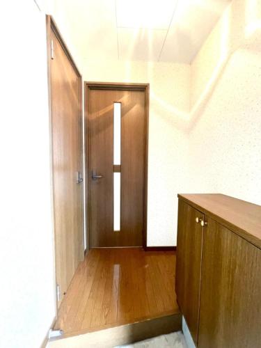an empty hallway with a wooden door in a room at Avidasion - Vacation STAY 12038 in Biei