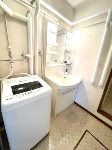 a white bathroom with a sink and a toilet at Avidasion - Vacation STAY 12038 in Biei