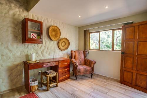 a room with a desk and a chair and a window at Kubu Safari Lodge in Hoedspruit