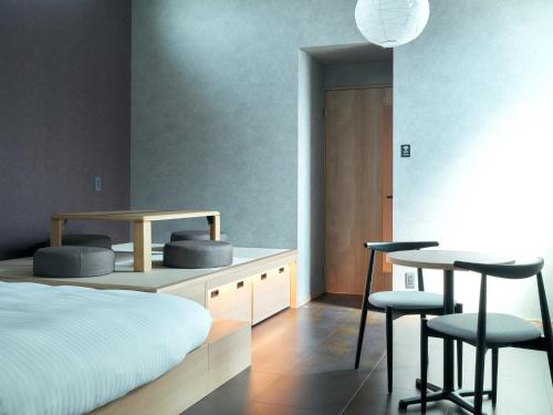 a bedroom with a bed and a table and chairs at Rakuten STAY Hakata Gion 301 Superior Room in Fukuoka