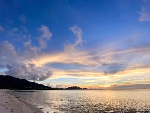 a sunset on the beach with a cloudy sky at Yonehara Beach Stay LUANA - Vacation STAY 38711v in Fukai