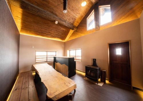 a room with a wooden table and a wood stove at Chamonix - Vacation STAY 67793v in Iiyama