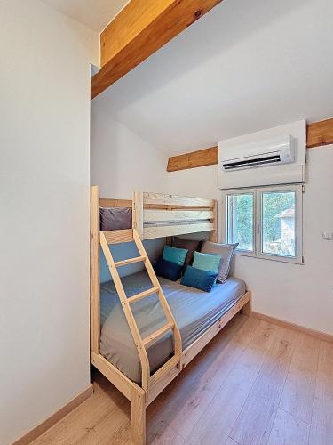 a bedroom with a bunk bed with a ladder at Villa Nature in Le Cannet-des-Maures