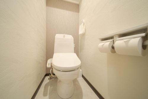 a bathroom with a white toilet in a stall at Tabi no yado Hanakeshiki Nanohana 1st floor - Vacation STAY 42962v in Yufuin