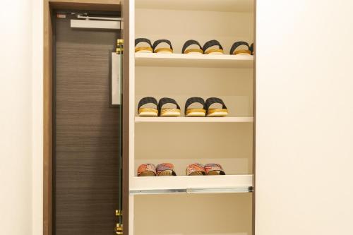 a walk in closet filled with lots of shoes at Tabi no yado Hanakeshiki Nanohana 1st floor - Vacation STAY 42962v in Yufuin