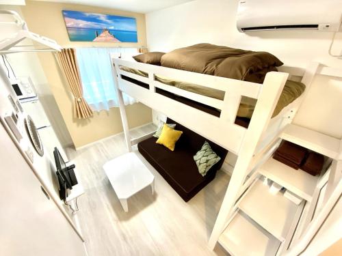 a bunk bed in a small room with a ladder at Le Soleil Asato - Vacation STAY 48630v in Naha