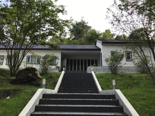 a house with stairs in front of a house at Guest House Paper Moon - Vacation STAY 45012v in Yamanakako