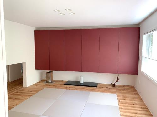 a living room with red cabinets and a table at Guest House Paper Moon - Vacation STAY 45012v in Yamanakako