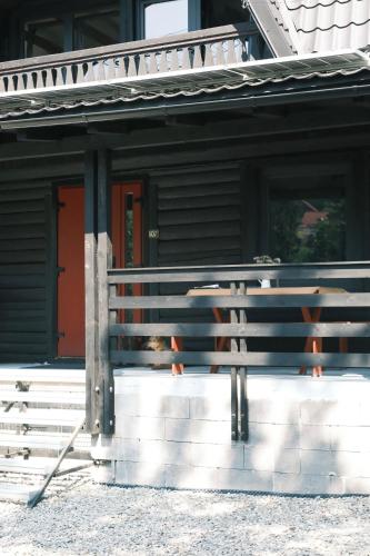 a bench in front of a house with a dog at Frank86 in Băile Tuşnad