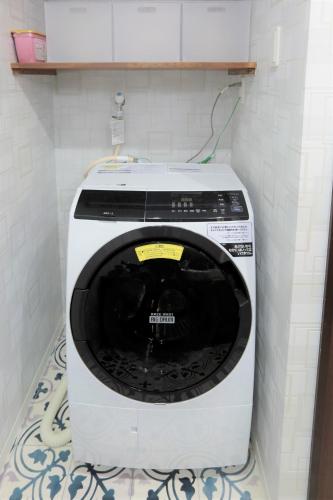 a washing machine in a corner of a room at ROYAL SUITE SAKAE - Vacation STAY 11483 in Nagoya