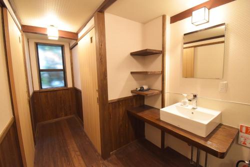 a bathroom with a sink and a mirror at Aburaya Bettei - Vacation STAY 50810v in Beppu