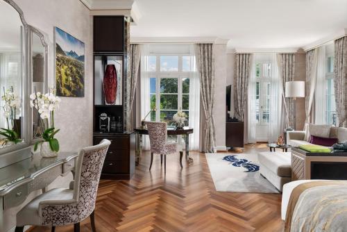 a bedroom with a bed and a living room at Grand Resort Bad Ragaz in Bad Ragaz