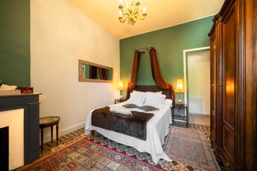 a bedroom with a bed and a fireplace at Villa Aimée Luxury Apartments with Heated Pool in Vals-les-Bains