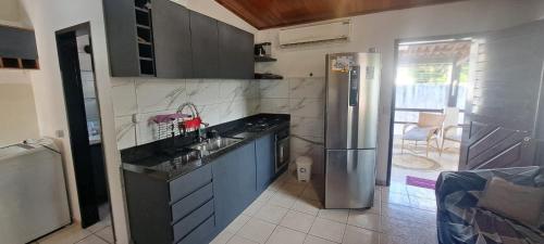 a kitchen with a sink and a refrigerator at Appartamento mobiliado in Natal