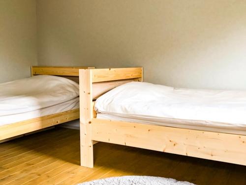 two bunk beds in a room with wooden floors at the room - Vacation STAY 79941v in Kannoura