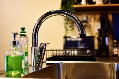a kitchen sink with a bottle of soap next to it at Kawachi no Yado - Vacation STAY 41785v in Kawachinagano