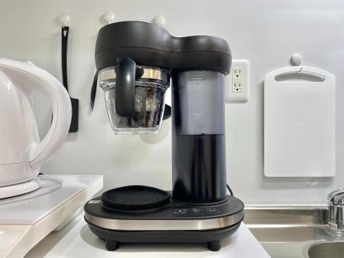 a black blender sitting on a kitchen counter at Le Soleil Asato - Vacation STAY 48667v in Naha