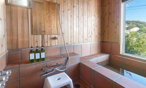 a bathroom with a sink and a window at Bay Coast Villa Kisami - Vacation STAY 33529v in Shimoda