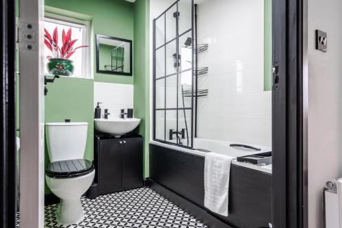 a bathroom with a toilet and a sink at 2 Bedroom Home with Garden and Free Parking in Litherland