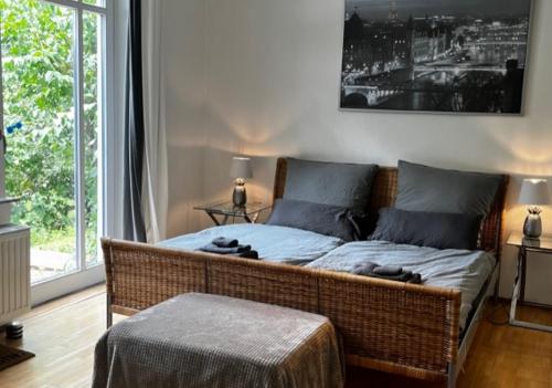 a wicker bed in a room with a large window at Landhaus am Deich in Cluvenhagen