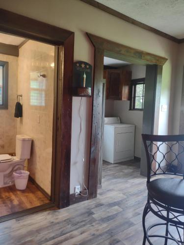 a living room with a door open to a bathroom at Home Place in McArthur