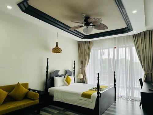 a bedroom with a bed and a ceiling fan at Phong Nha Lake House Resort in Phong Nha