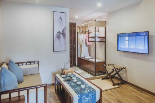 a living room with a mannequin and a tv at Dujiangyan Irrigation Project Puruna Hot Spring Hotel Panda Valley Store in Dujiangyan