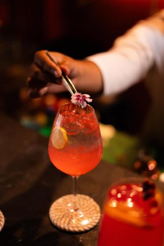 a person is stirring a drink in a martini glass at Padmaa Jaipur in Jaipur